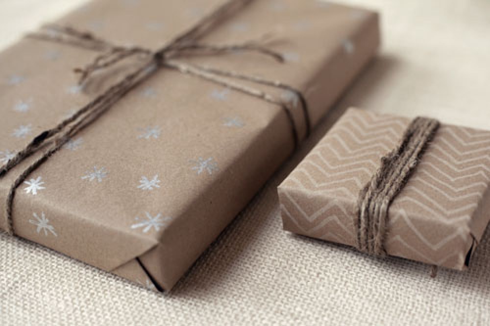 Завернуть подарок в оберточную. Бумага для упаковки подарков. Подарок в крафтовой бумаге. Упаковать подарок в бумагу. Упаковка подарка в крафтовую бумагу.